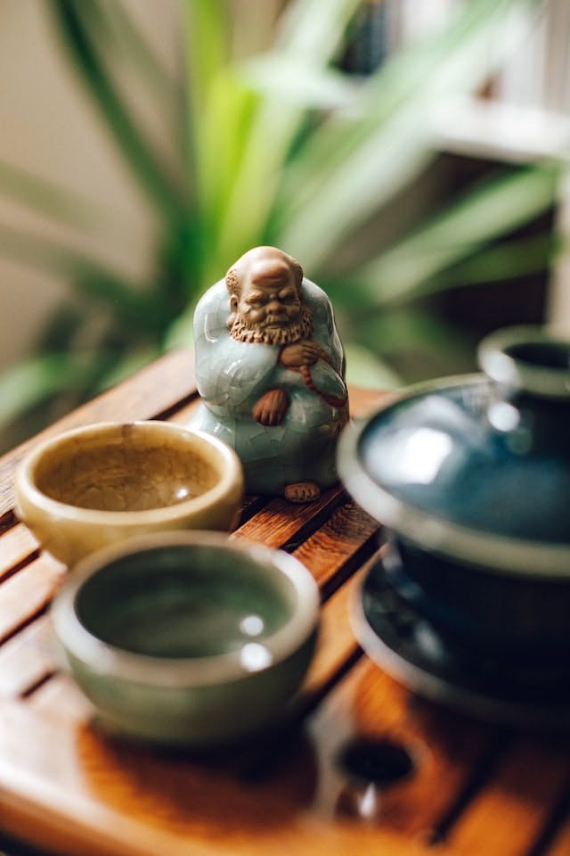 Gaiwan, Tea Cups and Tea Pet on Wooden Board